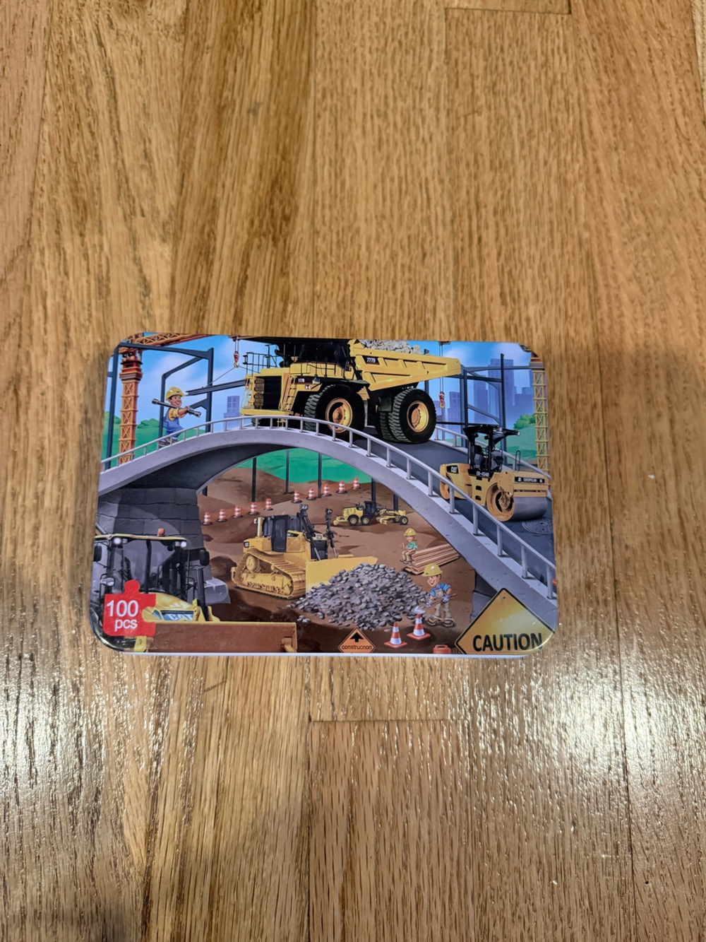 Puzzle-Lemon Construction Tin with Yellow Dump Truck
